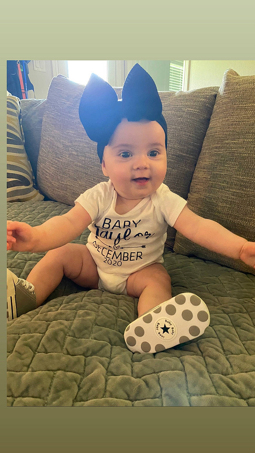 Kinsley joined the competition — help win amazing prizes! art, baby, baby_toddler_clothing, cap, child, comfort, couch, flooring, fun, happy, hat, head, human_leg, knee, pattern, person, smile, t_shirt, technology, textile