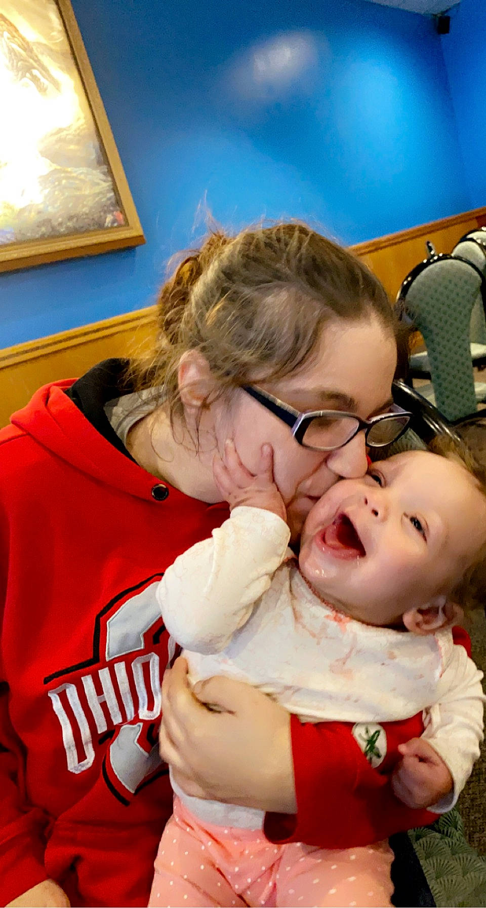 Ariannah is registered to the contest to win money with this photo: baby, child, event, eyewear, finger, fun, gesture, glasses, hair, happy, mouth, person, picture_frame, room, santa_claus, selfie, smile, t_shirt, tableware, toddler