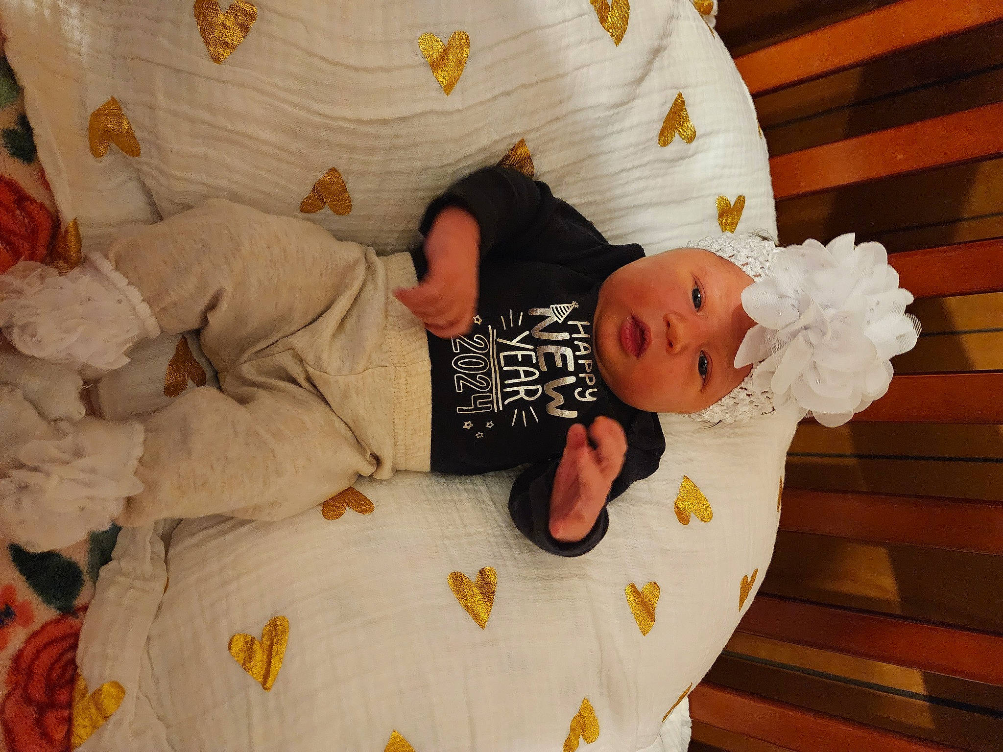 Mia is registered to the contest to win money with this photo: baby, baby_products, baby_toddler_clothing, bed, bed_sheet, bedding, bedroom, bedtime, child, comfort, happy, hat, headwear, linens, orange, pattern, person, product, room, textile