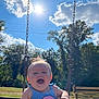Ellieanna is registered to the contest to win money with this photo: baby, child, swing, playground, outdoor, sunlight, sky, clouds, trees, bench, grass, smiling, happy, summer, nature, daylight, park, person, fun, blue_clothing