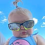 baby, child, sunglasses, ponytail, blue_sky, clouds, tank_top, flamingo, reflection, cute, outdoor, portrait, summer, sunny, face, fashion, casual, cheeks, person, headwear
