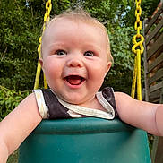 Ellieanna is registered to the contest to win money with this photo: baby, child, swing, outdoor, smiling, happy, yellow_chains, greenery, playground, joy, cute, portrait, summer, fun, nature, seat, person, infant, expression, daylight