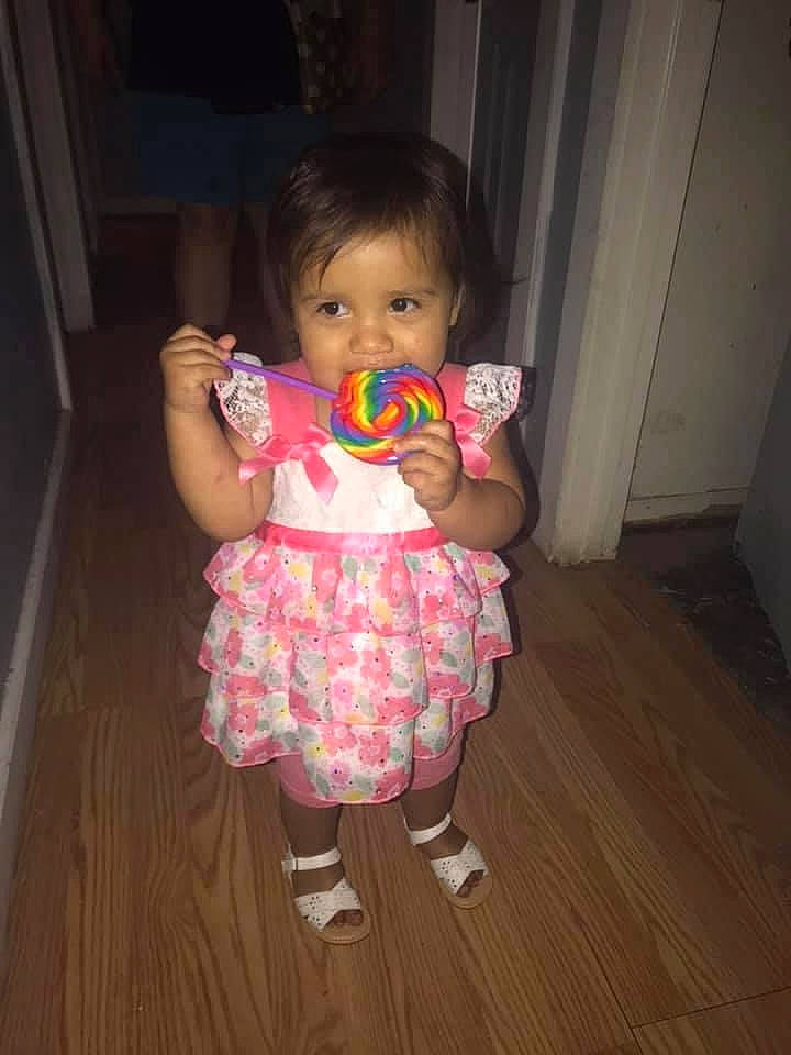 Kendra is registered to the contest to win money with this photo: baby, baby_toddler_clothing, cheek, dress, finger, floor, flooring, fun, happy, hardwood, human_body, iris, magenta, person, pink, purple, skin, toddler, varnish, wood