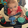 Emmett joined the competition — help win amazing prizes! baby, child, infant, walker, toy, red_shirt, blue_eyes, indoor, furniture, hand, face, curious, play, seat, person, young_child, home, floor, plastic, colorful