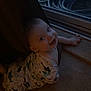 baby, infant, crawling, onesie, shark_pattern, curtain, door, glass_door, hose, indoor, carpet, smiling, child, face, hand, window, dark, cozy, floor, home