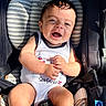 baby, child, car_seat, smiling, happy, sunlight, infant, clothing, seatbelt, portrait, cute, young_child, sitting, baby_clothes, striped, comfort, indoors, person, face, hands