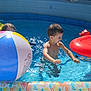 child, pool, water, beach_ball, inflatable_pool, summer, sunlight, playing, fun, splashing, toy, boy, girl, outdoor, happy, swimming, water_reflection, recreation, childhood, leisure