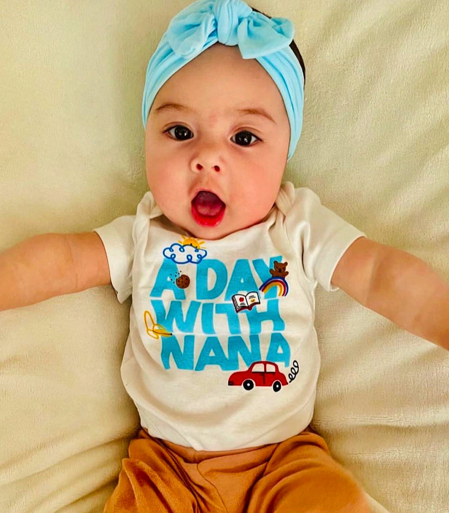 Camilla is registered to the contest to win money with this photo: baby, baby_products, baby_sleeping, baby_toddler_clothing, cap, cheek, child, face, fashion_accessory, happy, head, headgear, headwear, neck, pattern, peach, person, sleeve, smile, surprise