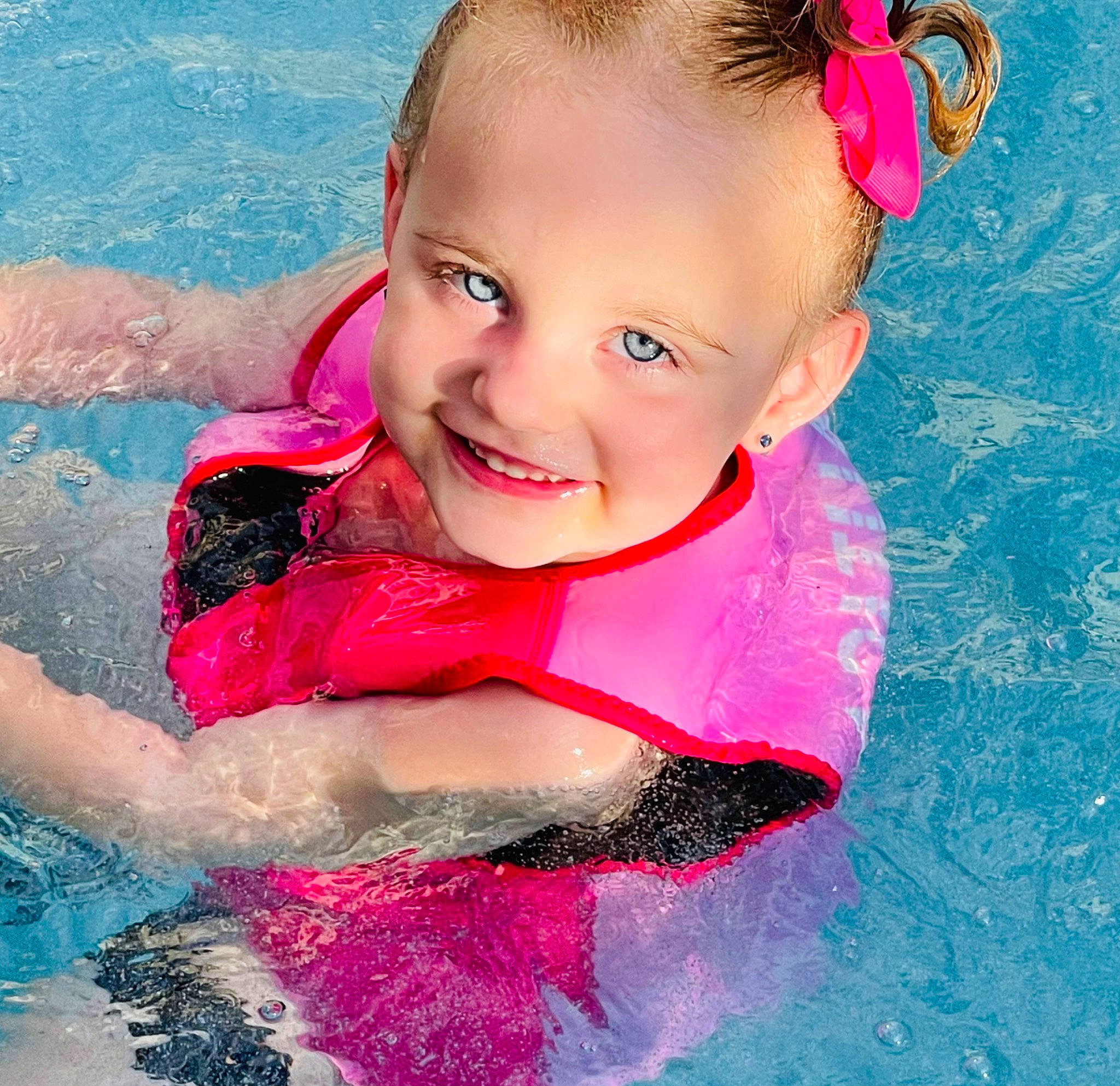Paislee joined the competition — help win amazing prizes! aqua, baby_float, bathing, child, facial_expression, fun, happy, joy, leisure, magenta, person, personal_protective_equipment, photograph, pink, recreation, red, smile, summer, swimmer, swimming_pool