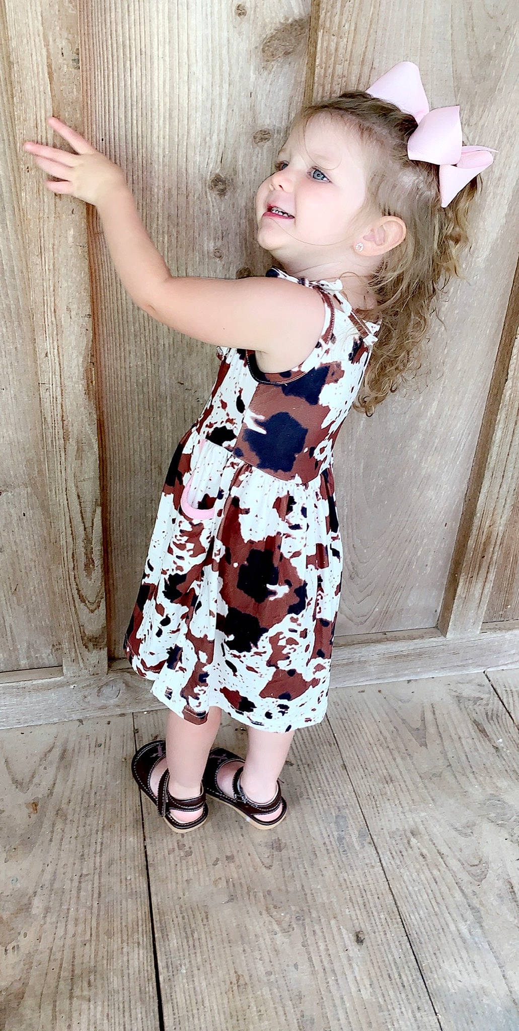 Raelynn is registered to the contest to win money with this photo: baby_toddler_clothing, beauty, child, child_model, clothing, day_dress, design, dress, fashion_accessory, fashion_design, footwear, leg, lip, pattern, person, photography, pink, plant, skin, toddler