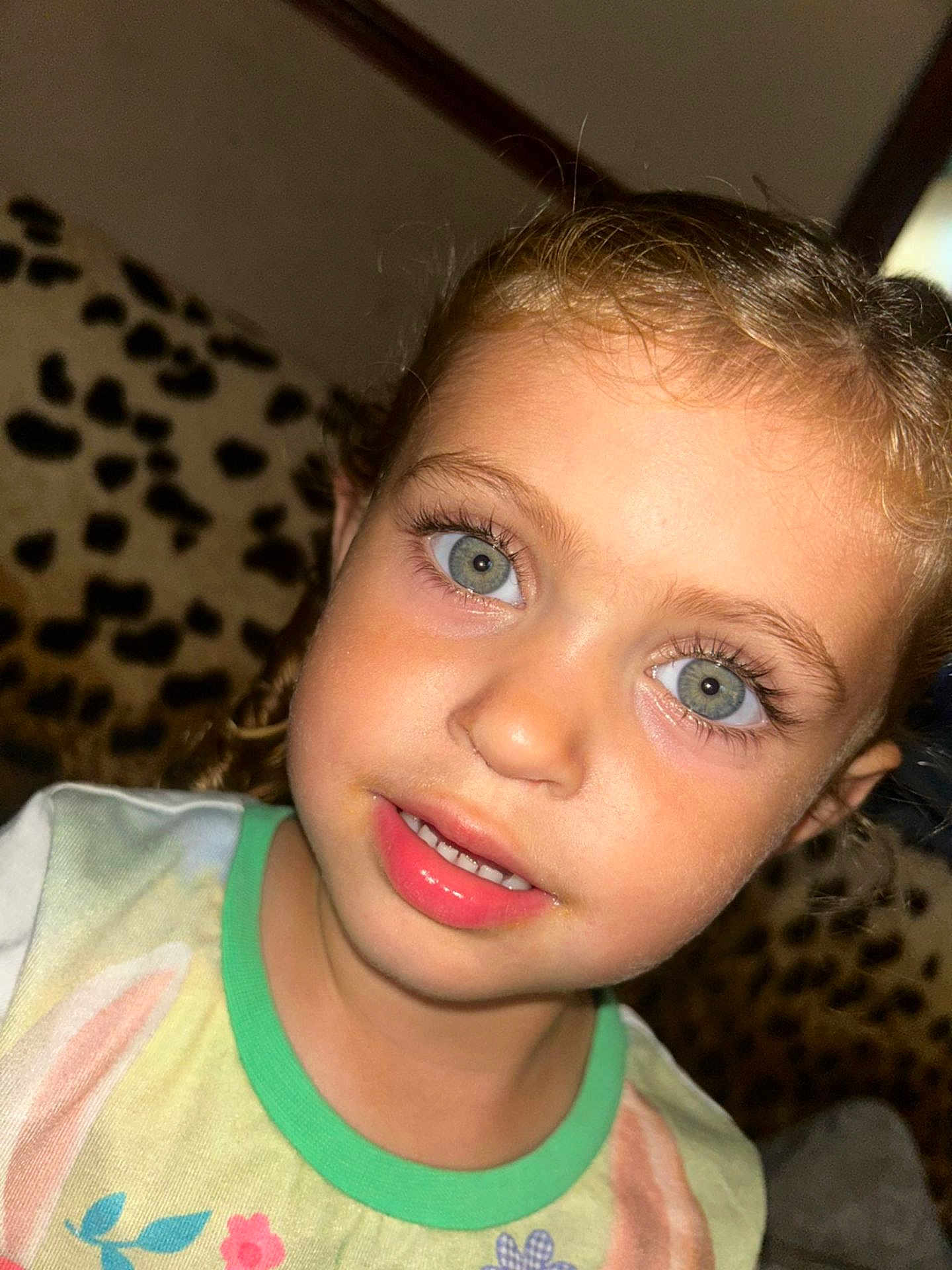 Arabella joined the competition — help win amazing prizes! child, face, blue_eyes, curly_hair, smile, portrait, close_up, couch, leopard_print, indoor, tshirt, young_child, person, skin, eyelashes, mouth, clothing, head, expression, cute