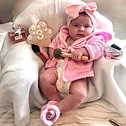 Mènciya participe au concours pour gagner de l'argent avec cette photo : baby, infant, pink_robe, headband_bow, bow, diaper, makeup_brush, perfume_bottle, high_heel, milestone_sign, necklace, pillow, blanket, sitting, chubby_legs, cozy, portrait, adorable, rosy_cheeks, soft_fabric