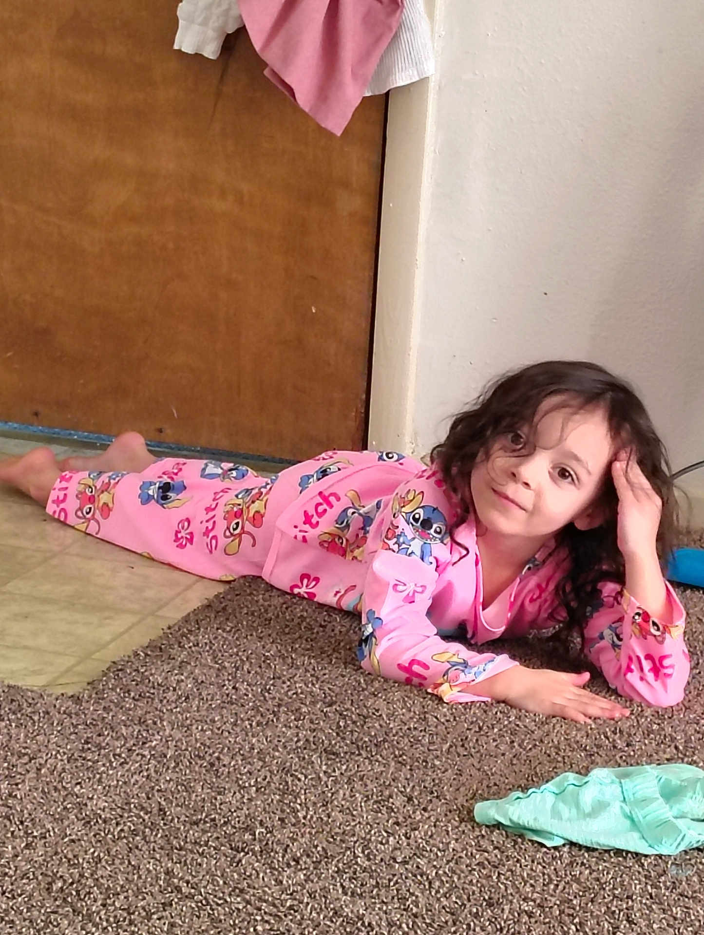 Melody joined the competition — help win amazing prizes! child, pajamas, pink, stitch, carpet, floor, indoor, smile, long_hair, curly_hair, relaxed, clothing, door, wall, hand, face, person, casual, young, playful