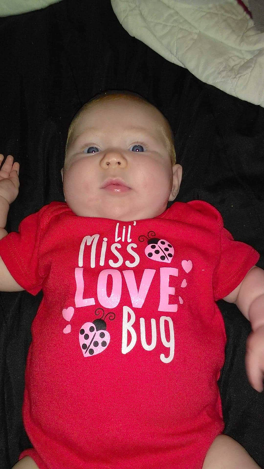 Brittany is registered to the contest to win money with this photo: baby, baby_products, baby_toddler_clothing, cheek, child, cool, head, lip, person, pink, product, red, skin, sleeve, smile, t_shirt, toddler, top