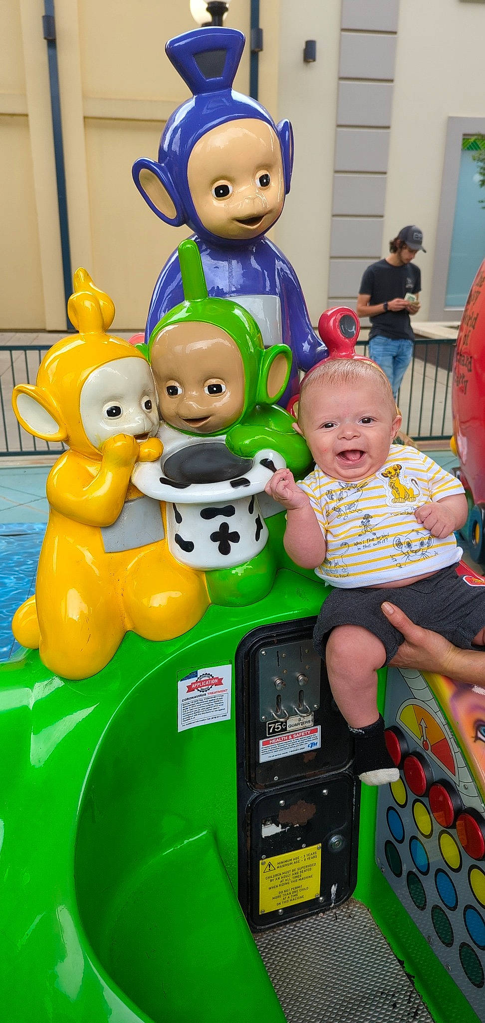 Kevin is registered to the contest to win money with this photo: child, event, fun, green, happy, leisure, party_supply, person, play, product, recreation, room, rubber_ducky, shorts, sitting, smile, snapshot, t_shirt, toddler, toy