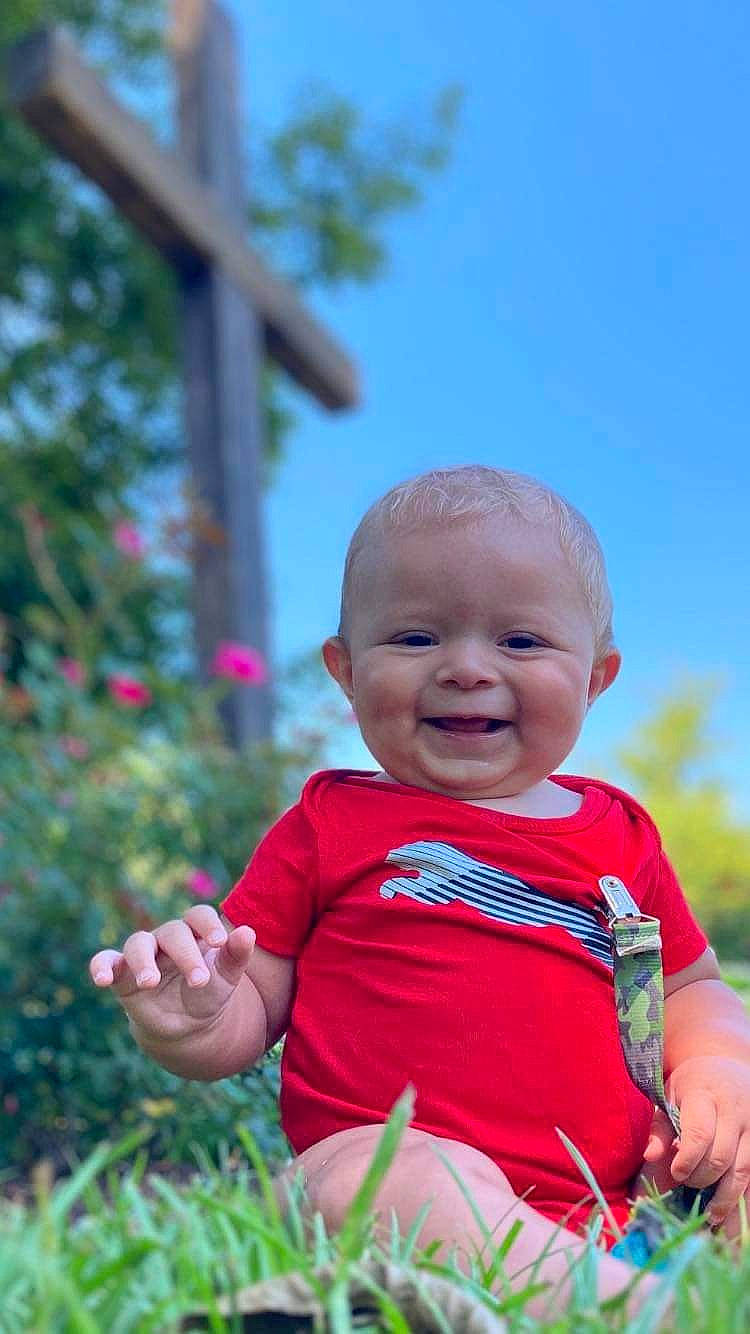 Kevin joined the competition — help win amazing prizes! baby, baby_toddler_clothing, child, eye, fun, gesture, grass, hand, happy, joy, laugh, leisure, people_in_nature, person, plant, recreation, sitting, skin, sky, smile