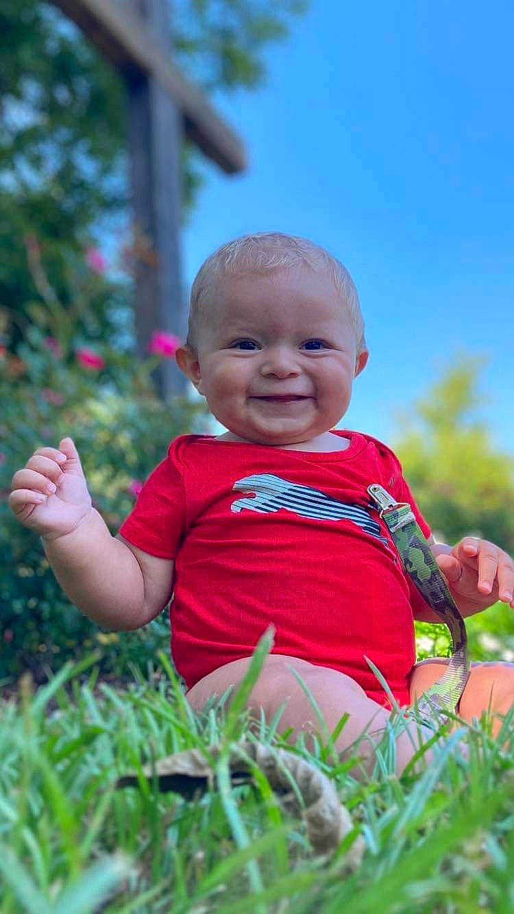 Kevin is registered to the contest to win money with this photo: baby, baby_toddler_clothing, child, eye, fun, grass, grass_family, happy, joy, leisure, nose, people_in_nature, person, plant, play, portrait_photography, sitting, skin, sky, smile