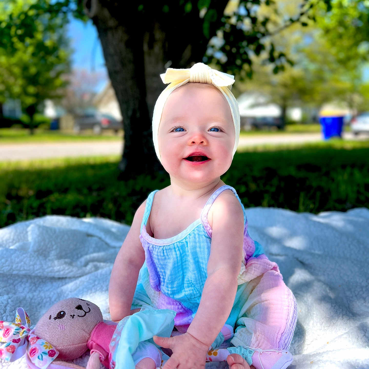 Lainey joined the competition — help win amazing prizes! baby, car, clothing, dress, face, grass, happy, head, laughing, outdoors, person, photography, plant, portrait, sitting, summer, toy, transportation, tree, vehicle