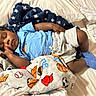 baby, sleeping, blanket, bed, blue_shirt, gray_shorts, socks, infant, cozy, soft, face, hand, child, cute, resting, comfort, home, indoors, peaceful, toddler
