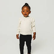 Jayleen participe au concours pour gagner de l'argent avec cette photo : toddler, child, standing, barefoot, black_leggings, cream_sweater, braids, yellow_beads, studio, white_background, portrait, cute, fashion, young_child, person, smiling, innocent, happy, posing, full_body