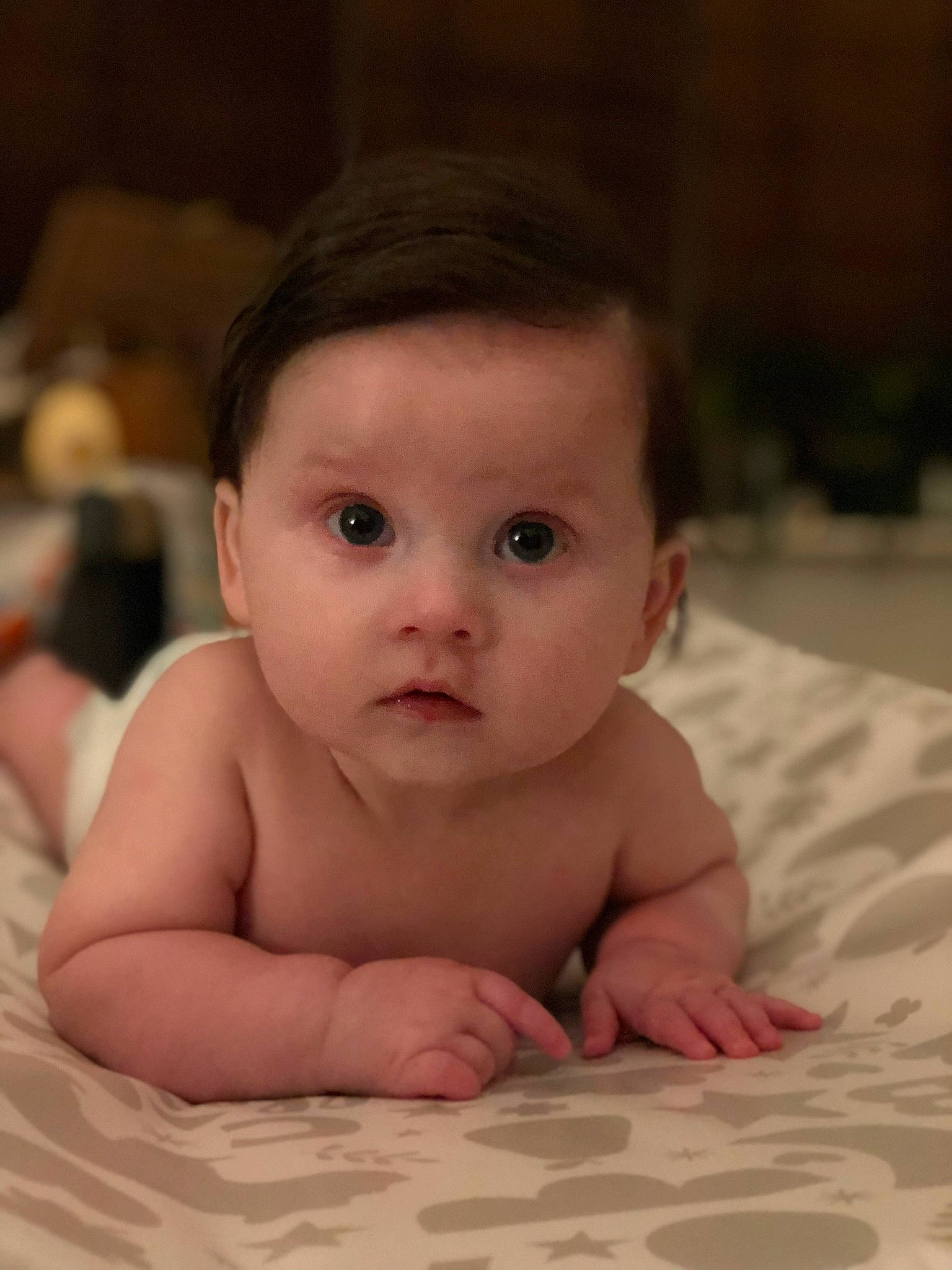 Dana is registered to the contest to win money with this photo: baby, cheek, child, chin, crawling, eye, face, head, iris, lip, mouth, nose, person, photography, sitting, skin, smile, surprise, toddler, tummy_time