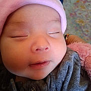 Bella joined the competition — help win amazing prizes! baby, sleeping, close_up, face, hat, pink, grey_clothing, soft_texture, infant, peaceful, child, portrait, cute, adorable, resting, young_child, warm, indoor, human, wearing