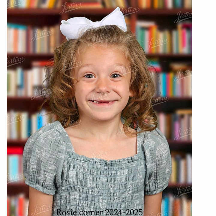 Rosalie is registered to the contest to win money with this photo: book, bookcase, bookstore, child, clothing, face, female, furniture, girl, head, indoors, library, people, person, photography, portrait, publication, shelf, shop, text