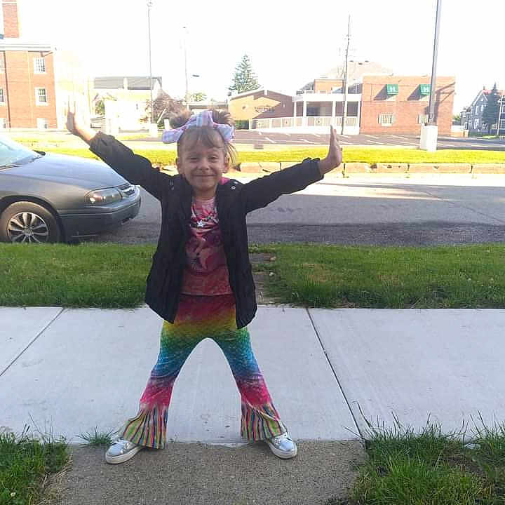 Rosie joined the competition — help win amazing prizes! architecture, building, city, clothing, coat, face, grass, head, neighborhood, outdoors, path, person, photography, plant, portrait, road, shelter, sidewalk, street, urban