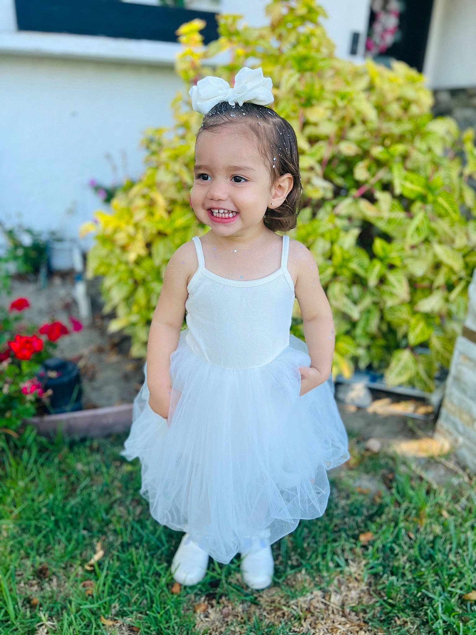 Mia is registered to the contest to win money with this photo: baby, baby_toddler_clothing, child, day_dress, dress, event, fashion_accessory, flash_photography, flower, fun, grass, hair_accessory, happy, joy, one_piece_garment, pattern, people_in_nature, person, plant, portrait_photography