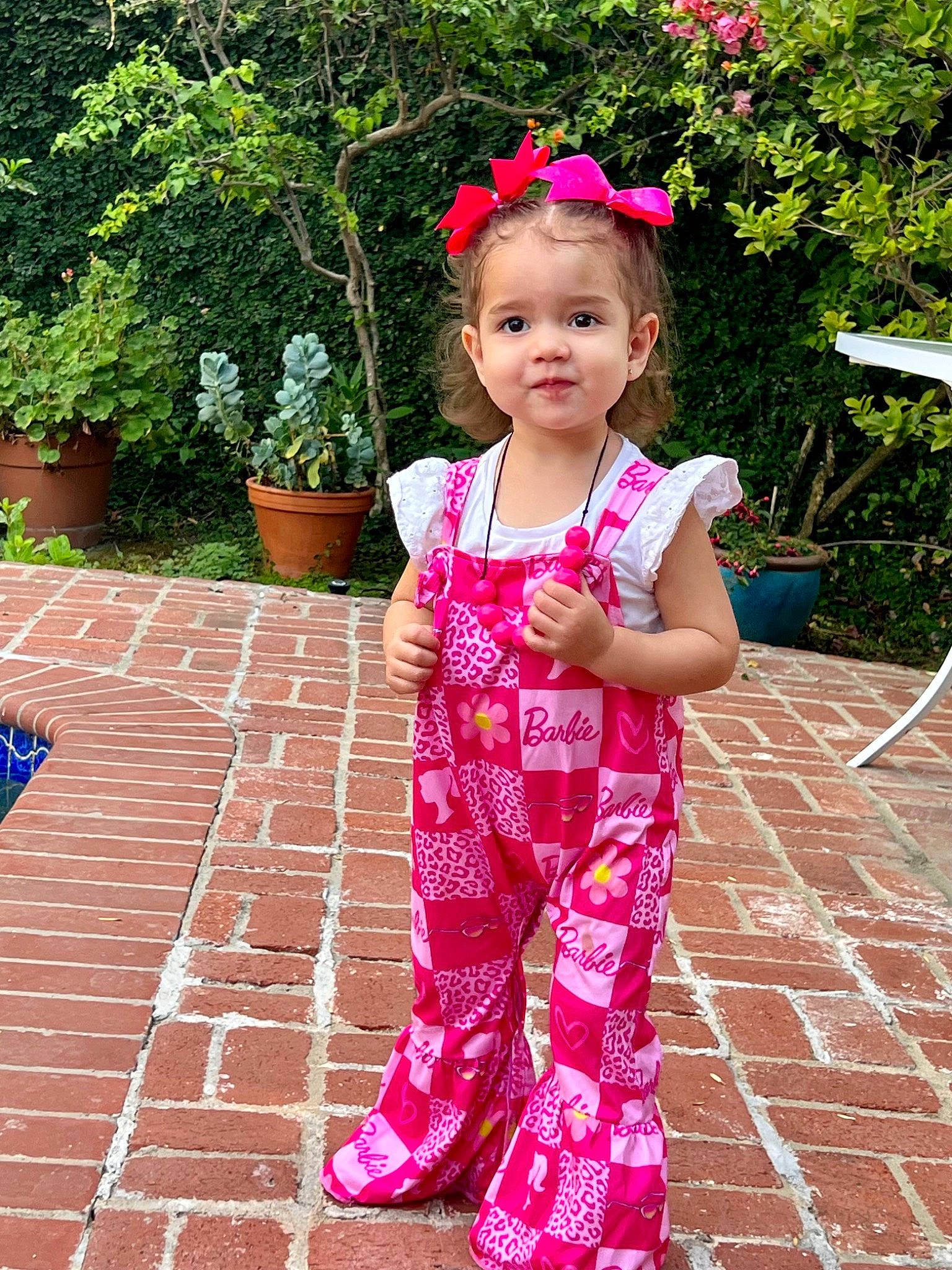 Mia joined the competition — help win amazing prizes! active_pants, baby_toddler_clothing, child, flooring, flowerpot, fun, grass, happy, houseplant, leisure, magenta, outdoor_furniture, pattern, people_in_nature, person, pink, plant, sleeve, smile, toddler