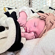 Matilda is registered to the contest to win money with this photo: baby, sleeping, blanket, headband, infant, cozy, soft, closeup, peaceful, cute, child, indoors, rest, comfort, pink, white, black, portrait, hands, face