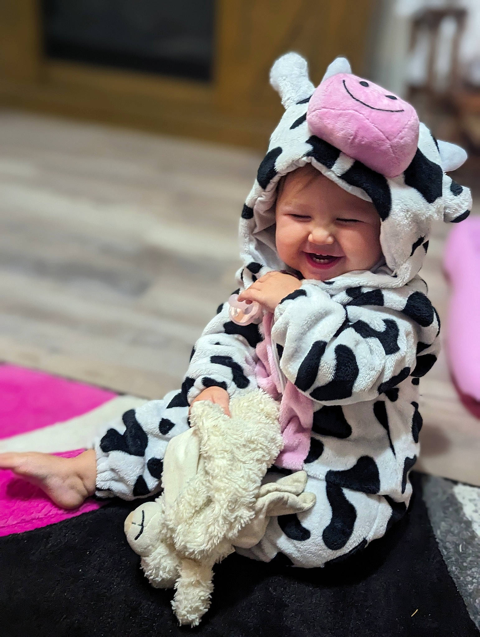 Gabriella is registered to the contest to win money with this photo: baby, baby_toddler_clothing, child, comfort, costume, fashion_accessory, fur, happy, headgear, headwear, joy, magenta, military_camouflage, pattern, person, pink, purple, sitting, sleeve, smile