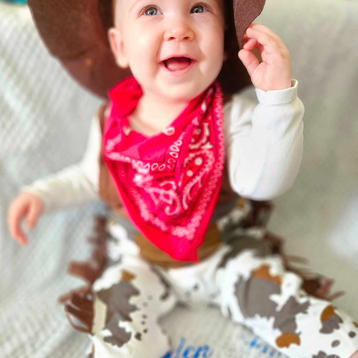 Jayden-Jamie is registered to the contest to win money with this photo: accessories, baby, bodypart, clothing, costume, cowboyhat, face, finger, hand, happy, hat, head, pants, person, photography, portrait, scarf, sitting, smile, sunhat