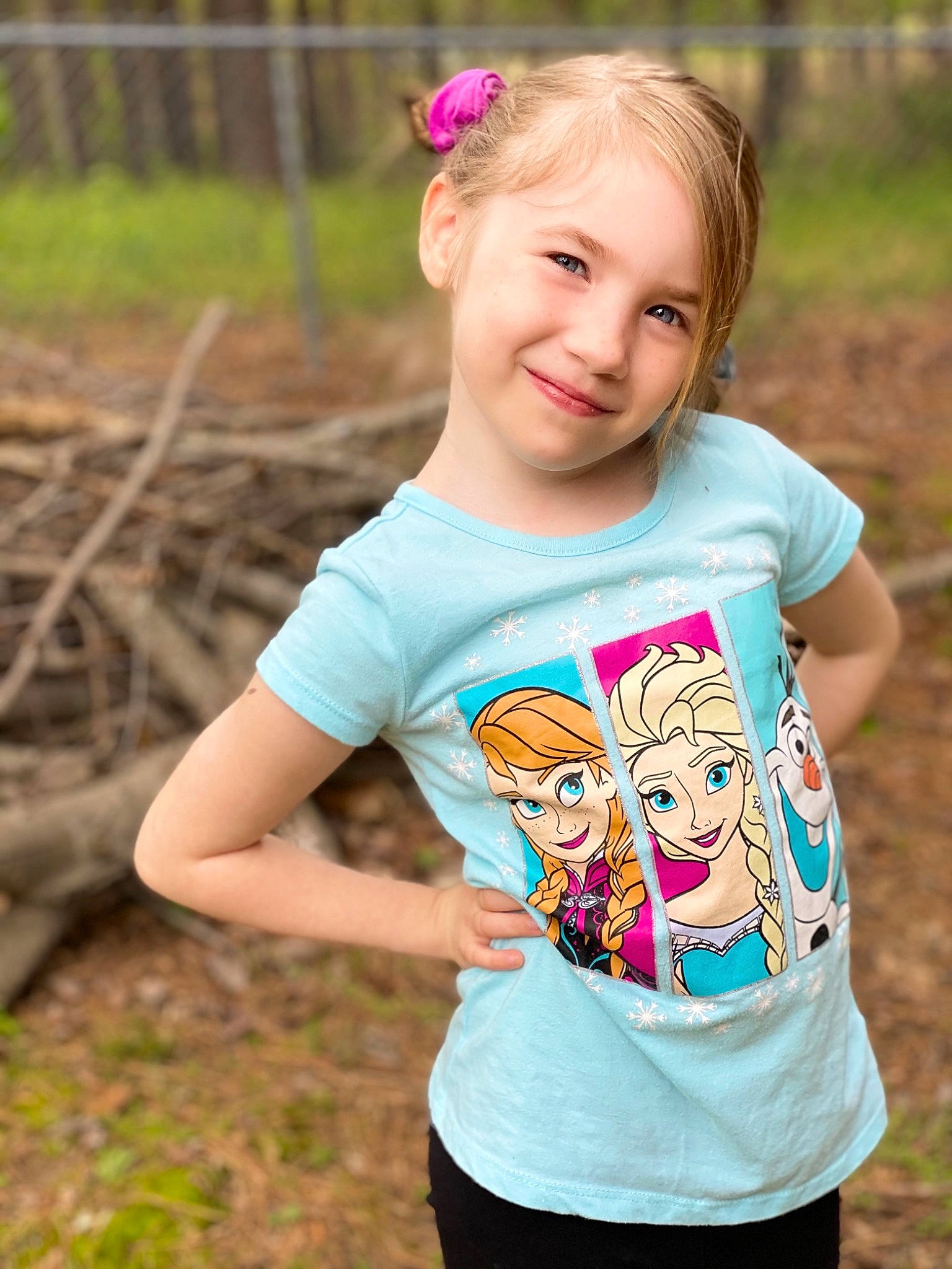 Arianna is registered to the contest to win money with this photo: baby_toddler_clothing, clothing, face, grass, happy, head, joy, leaf, magenta, natural_environment, neck, people_in_nature, person, pink, plant, sleeve, smile, standing, summer, t_shirt