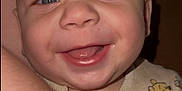 Leo is registered to the contest to win money with this photo: apparel, arm, baby, blue_eyes, child, close_up, cute, expression, face, happy, indoor, infant, onesie, person, portrait, skin, sleepwear, smile, tattoo, winnie_the_pooh