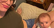 Paisley joined the competition — help win amazing prizes! woman, baby, glasses, bed, candle, nightstand, casual, indoor, relaxing, person, infant, clothing, jeans, shorts, lamp, notebook, cup, remote_control, footwear, home