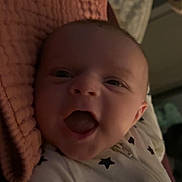 Paisley is registered to the contest to win money with this photo: baby, infant, smile, laugh, face, onesie, stars, blanket, textile, cozy, indoors, cute, child, happy, portrait, young, sleepwear, rest, comfort, expression