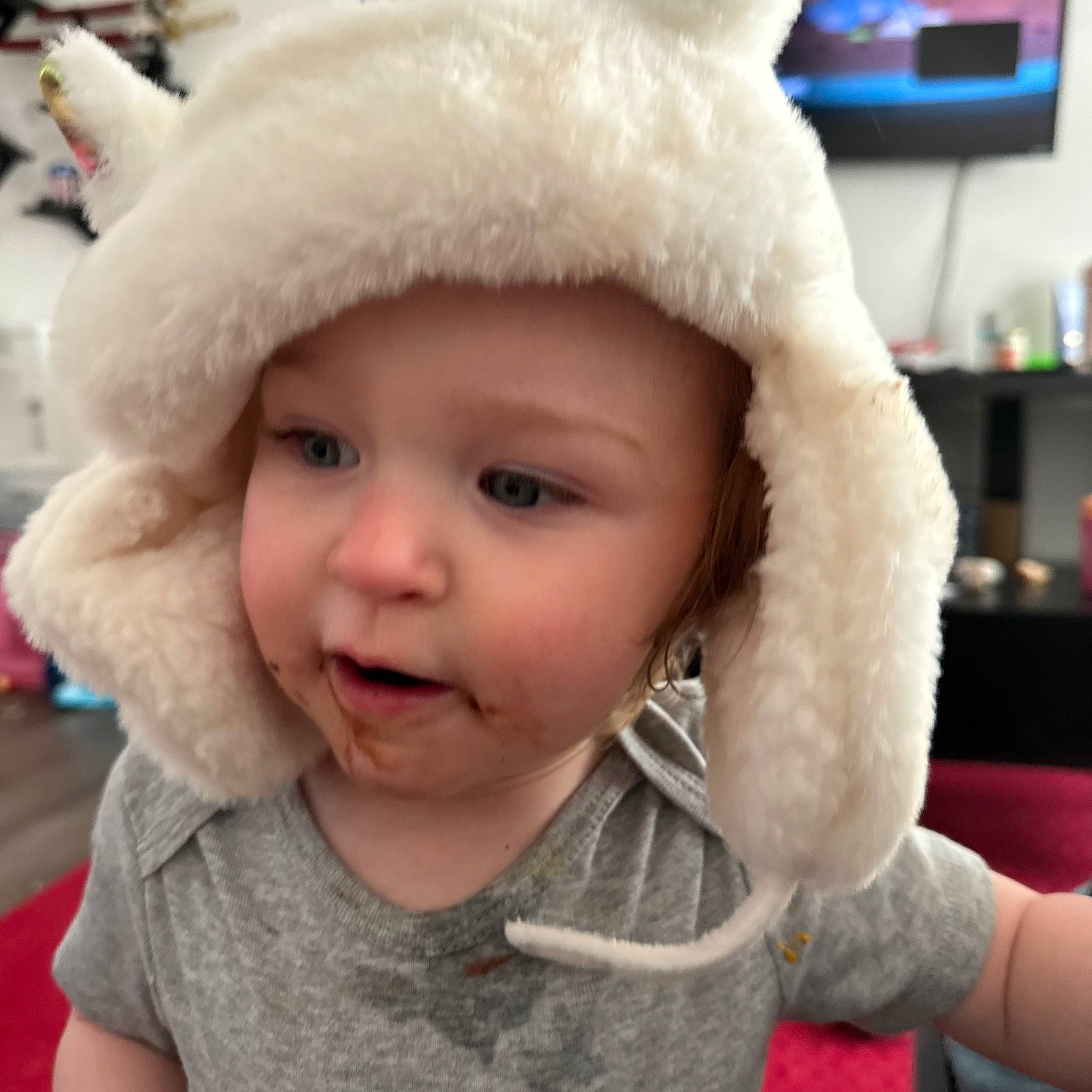 Ensley is registered to the contest to win money with this photo: baby, baby_toddler_clothing, cap, child, costume_hat, eye, fashion_accessory, fur, fur_clothing, happy, hat, headgear, headwear, lip, nose, person, skin, sleeve, textile, toddler