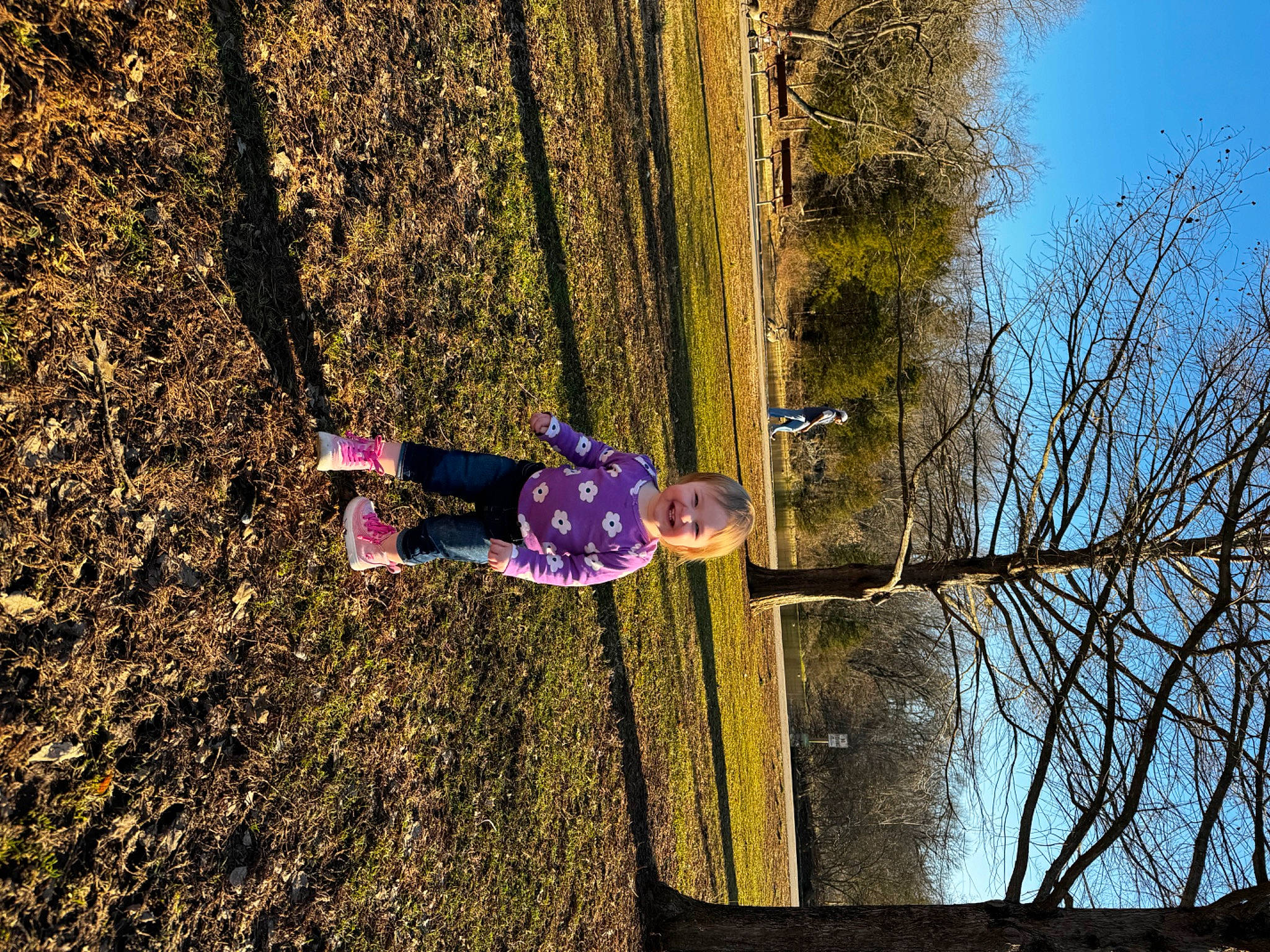 Ensley is registered to the contest to win money with this photo: branch, fun, grass, joy, landscape, leaf, leisure, magenta, nature, people_in_nature, person, plant, recreation, sky, sunlight, tints_and_shades, tree, trunk, vegetation, water
