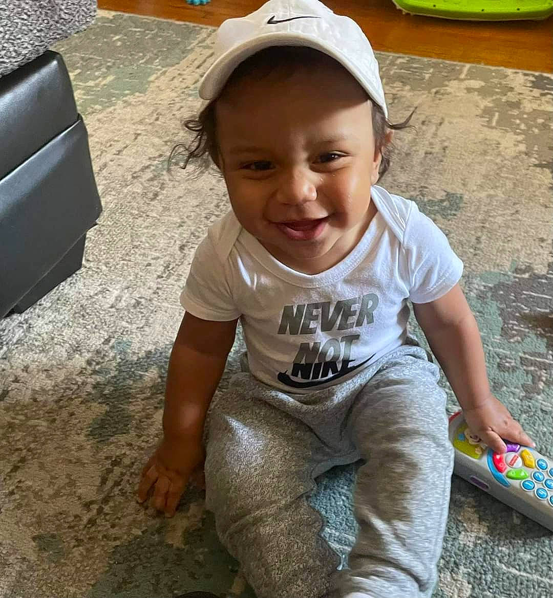 Cash joined the competition — help win amazing prizes! asphalt, baseball_cap, cap, child, cool, flooring, fun, happy, joy, leisure, person, play, road_surface, sitting, skin, sleeve, smile, soil, t_shirt, thigh