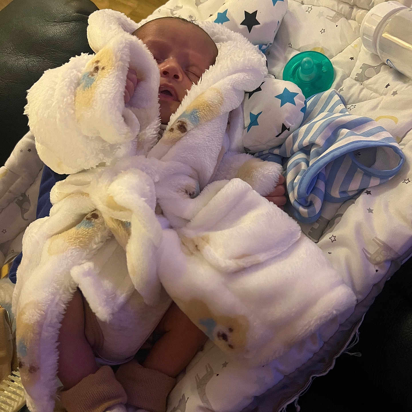 Jakari is registered to the contest to win money with this photo: newborn, baby, infant, sleeping, blanket, swaddle, plush_toy, stuffed_animal, pacifier, baby_bottle, crib, bedding, stars, indoor, cozy, portrait, closed_eyes, peaceful, nursery, soft_lighting