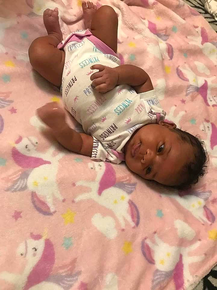 Rori Lynne is registered to the contest to win money with this photo: baby, baby_products, baby_toddler_clothing, bedding, bedtime, cheek, child, comfort, fun, happy, head, human_body, linens, muscle, pattern, person, pink, room, skin, textile