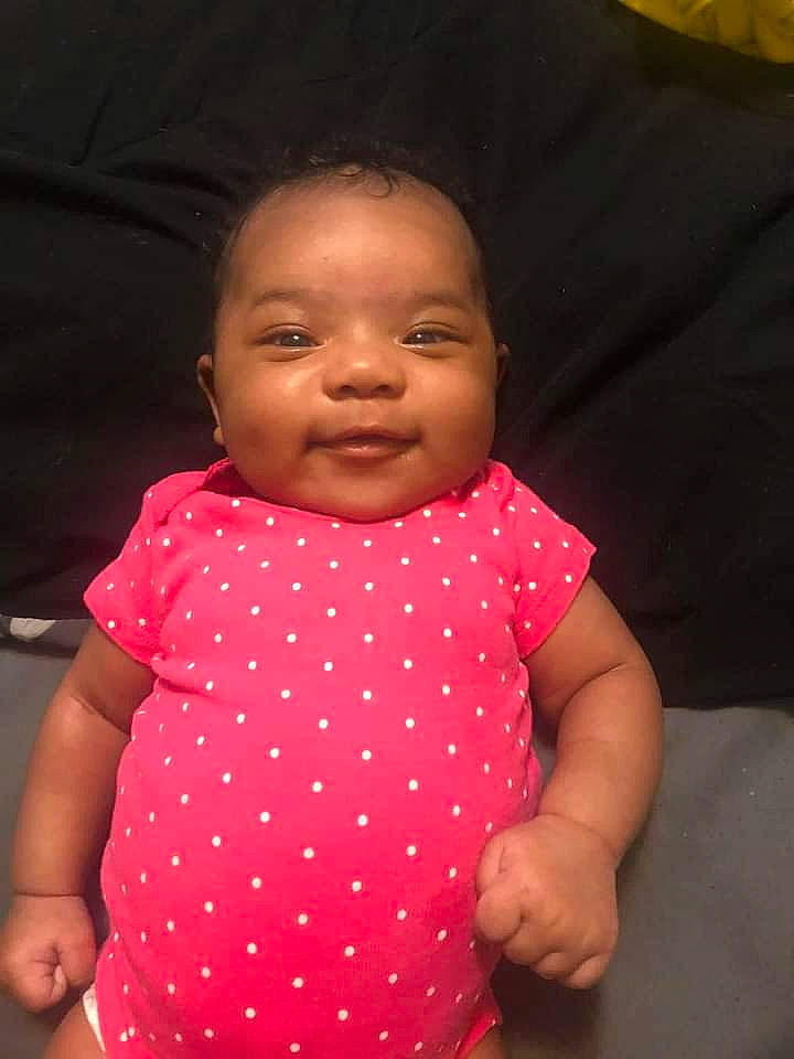 Rori Lynne is registered to the contest to win money with this photo: arm, baby, baby_toddler_clothing, cheek, chin, eye, finger, gesture, happy, human_body, lip, mouth, neck, nose, person, pink, shoulder, skin, sleeve, smile