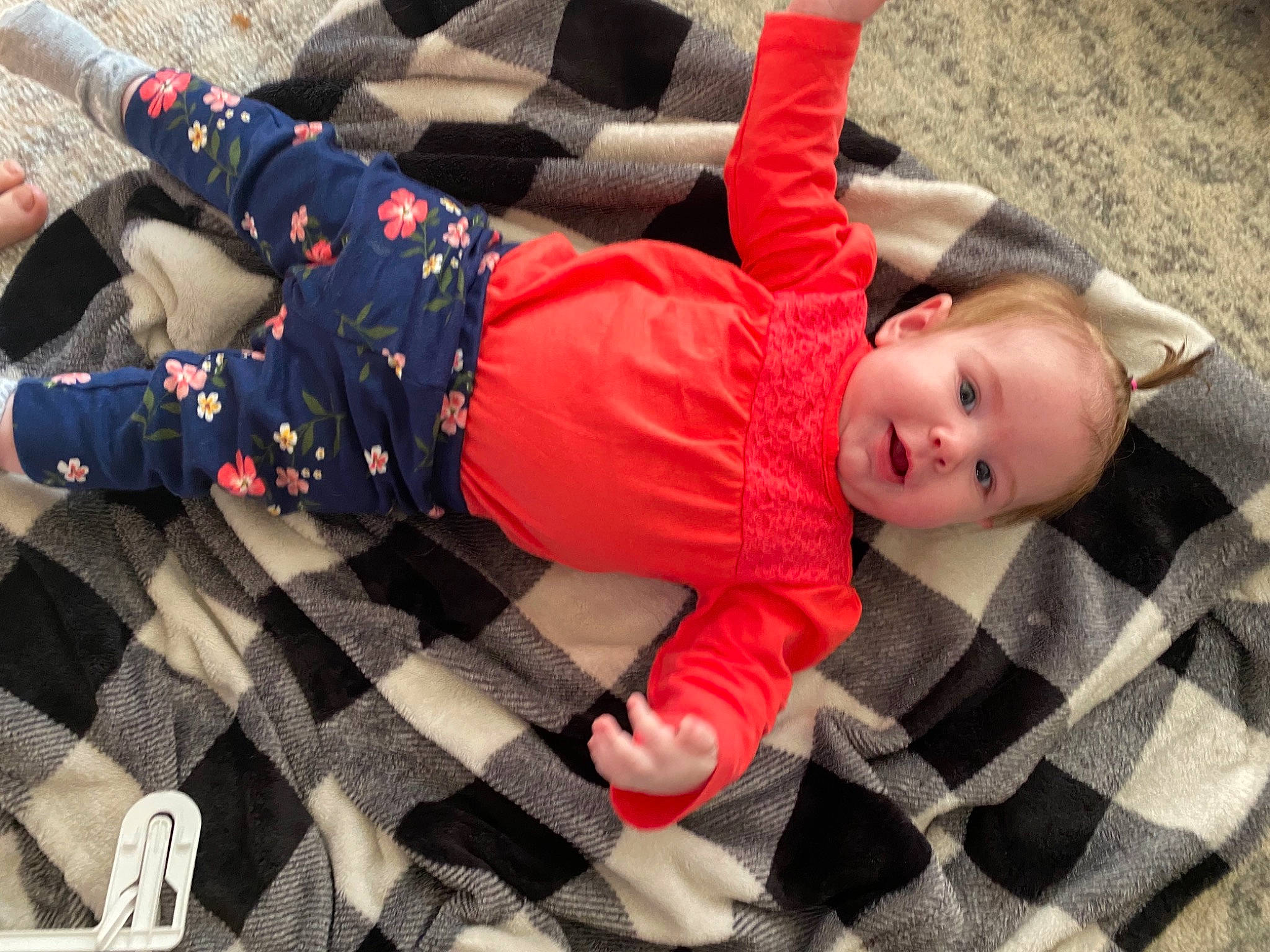 Ella joined the competition — help win amazing prizes! baby, baby_products, baby_toddler_clothing, carmine, child, comfort, flooring, foot, fun, grass, human_leg, knee, pattern, person, plaid, room, sitting, sleeve, textile, thigh