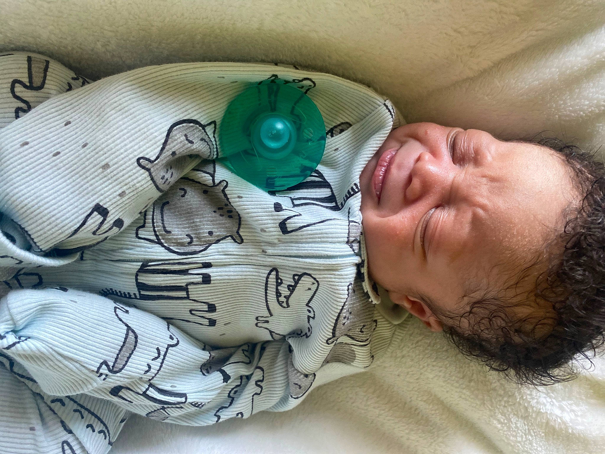 Gianni is registered to the contest to win money with this photo: baby, baby_products, baby_sleeping, bedding, bedtime, child, comfort, fashion_accessory, happy, headgear, linens, mechanical_fan, mouth, pattern, person, personal_protective_equipment, plastic, room, smile, textile