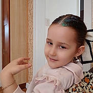 Prayla is registered to the contest to win money with this photo: child, girl, indoor, portrait, smile, pink_hoodie, glitter, hair, hand, bracelet, earring, ruffles, blanket, leopard_print, furniture, wall, door, person, casual, cozy