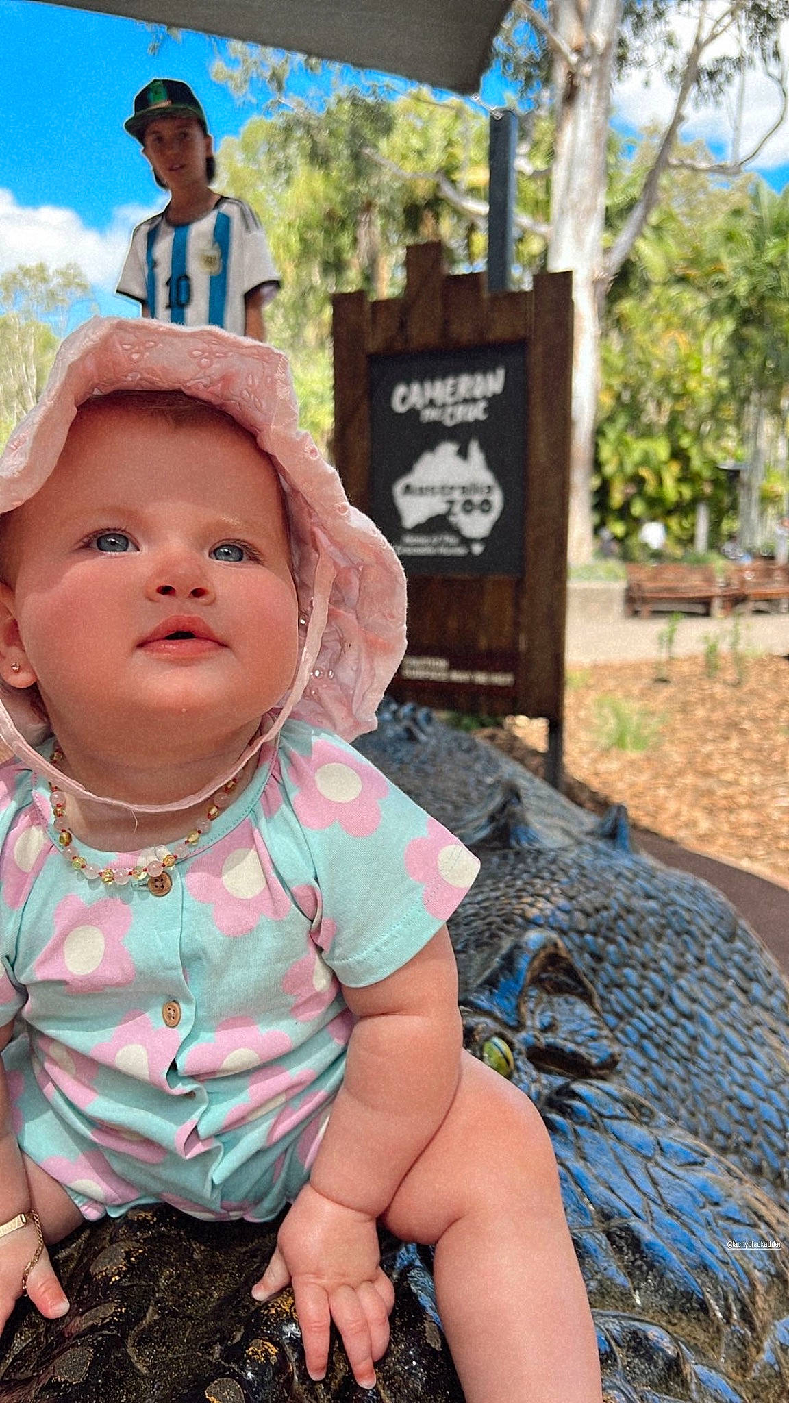 Macy joined the competition — help win amazing prizes! baby, baby_toddler_clothing, child, fun, garden, grass, happy, hat, headwear, leisure, person, plant, recreation, sitting, skin, sky, soil, sun_hat, t_shirt, toddler