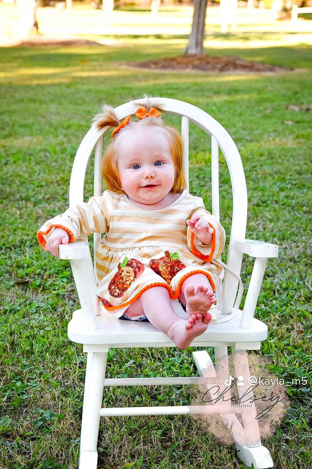 Kenleigh joined the competition — help win amazing prizes! baby, baby_toddler_clothing, chair, dress, face, grass, happy, human_body, leaf, leisure, orange, people_in_nature, person, pink, plant, product, public_space, skin, smile, toddler