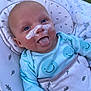Rowan is registered to the contest to win money with this photo: baby, infant, smiling, tongue_out, face_cream, blue_eyes, onesie, smiley_face, baby_seat, cushion, outdoor, grass, child, cute, playful, happy, skin, head, person, portrait