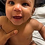 baby, smiling, curly_hair, dimples, bare_chest, hand, blanket, diaper, infant, cute, happy, person, skin, indoors, closeup, child, joyful, holding, soft, young